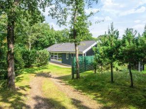 a green house in the middle of a yard at 6 person holiday home in Ansager in Ansager