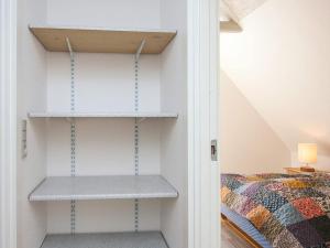 a room with shelves next to a bed at 4 person holiday home in Ansager in Ansager