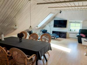 a dining room with a black table and chairs at 6 person holiday home in Thisted in Thisted