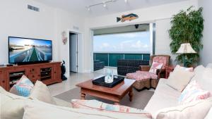 a living room with a couch and a tv at 335 Mariners Club in Key Largo