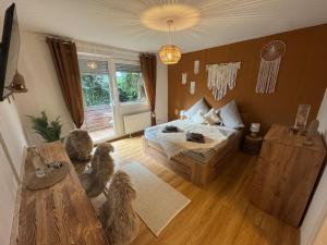 a bedroom with two dogs sitting in front of a bed at BOHO Apartment Terra in Bad Reichenhall