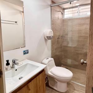 a bathroom with a toilet and a sink and a shower at Apartamentos 438 in Ríohacha +59 photos