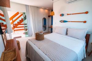 a bedroom with a bed in a room with stairs at Pousada Sollari in Mundaú +64 photos