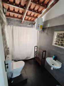 a bathroom with a toilet and a sink at Maya Mindelo Studio T1 in Mindelo