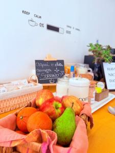 a basket of fruit sitting on a table at MAKTVB Europa - Hostal Boutique in Santiago