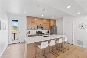 a kitchen with a counter and some chairs in it at Jordanelle Express Gondola Condo 3 BR Hot Tub in Cranmer