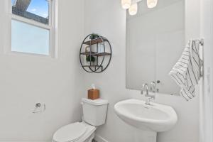 a white bathroom with a toilet and a sink at Jordanelle Express Gondola Condo 3 BR Hot Tub in Cranmer +17 photos