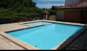 a large swimming pool with blue water at Maravista in Itamaracá +6 photos