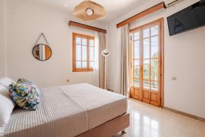 a bedroom with a bed and a sliding glass door at Querencia Residence in Khánia