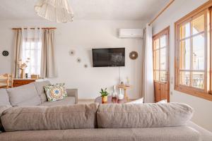 a living room with a couch and a tv at Querencia Residence in Khánia
