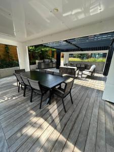 a patio with a table and chairs on a deck at Vibrant 1 Bedroom Condo Apt in Toronto