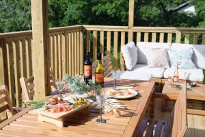 a wooden table with food and drinks on a deck at Vista Fuji Retreat in Kannami
