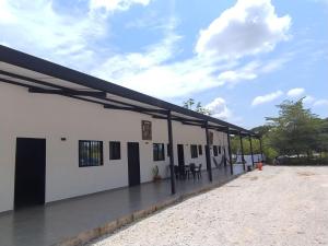 a large white building with a black roof at JyM apartaestudios in Doradal