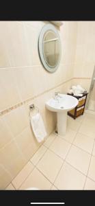 a white bathroom with a sink and a mirror at Sonas house in Kilkenny