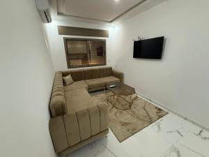 a living room with a couch and a tv at Nour DAsilah 8 in Asilah