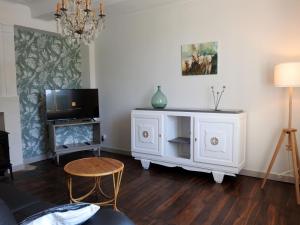 a living room with a tv and a white cabinet at Gîte rénové à Dommartin-le-Franc : confort, verdure et activités à proximité du lac du Der - FR-1-611-64 in Dommartin-le-Franc