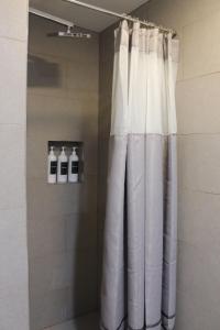 a shower with white curtains in a bathroom at Beautiful 2 BED 2 BATH Soaker Tub in Albany