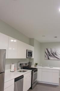 a kitchen with white cabinets and stainless steel appliances at Beautiful 2 BED 2 BATH Soaker Tub in Albany