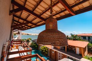 a large light hanging from the ceiling of a balcony at Pousada Sollari in Mundaú