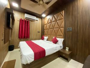 a bedroom with a large bed with a red blanket at Hotel Prince Palace in Patiāla