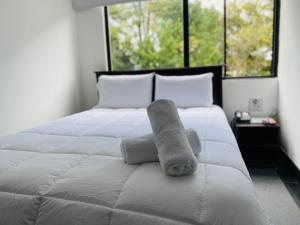 a stuffed animal on the end of a bed at Latín Boutique in Bogotá +14 photos