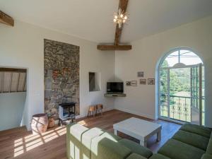 a living room with a couch and a fireplace at 3-bedroom holiday home with panoramic view in Haltinne