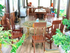 a dining room with a table and wooden chairs at Dream House Homestay in Thuận Biên