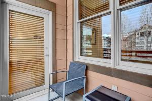 a blue chair sitting on a porch next to a window at Ski-In Ski-Out Zephyr 1 Bedroom Condo 2204 in Winter Park