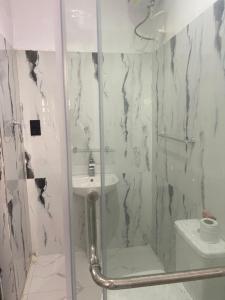 a bathroom with a shower and a sink at Extravaganza Stay in Lagos +8 photos