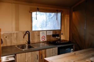 a kitchen with a sink and a window at Koondrook Glamping Retreat in Koondrook