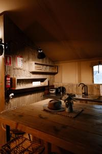 a kitchen with a wooden table and a sink at Koondrook Glamping Retreat in Koondrook +53 photos
