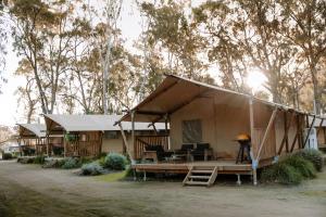a large tent with a table and a piano at Koondrook Glamping Retreat in Koondrook