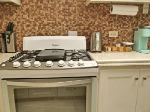a white stove top oven in a kitchen at Casa Amarilla St Michael in Bridgetown