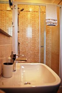 a bathroom with a white tub and a shower at Rooms Edda in Umag