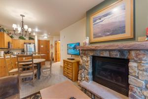 a living room with a fireplace and a dining room at Expedition Station 8574 by Summit County Mountain Retreats in Snake River Health Services Incorporated Heliport
