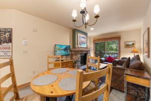 a living room with a table and a fireplace at Expedition Station 8574 by Summit County Mountain Retreats in Snake River Health Services Incorporated Heliport