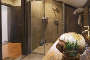 a shower with a glass door in a bathroom at QingXi Hotel in Fenghuang +75 photos