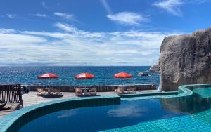 a swimming pool with a view of the ocean at Kohtao Hillside resort in Ko Tao