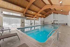a pool in a building with a wooden ceiling at Quicksilver 1658 by Summit County Mountain Retreats in Keystone