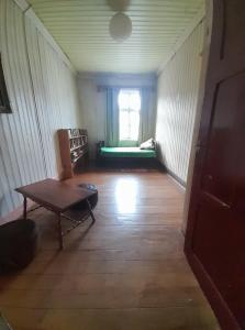 a living room with a table and a couch at Casa Purísima in Puerto Varas