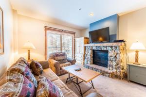 a living room with a couch and a fireplace at Expedition Station 8581 by Summit County Mountain Retreats in Snake River Health Services Incorporated Heliport
