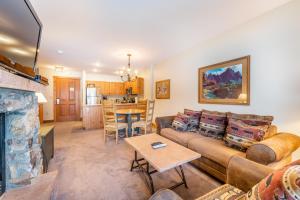 a living room with a couch and a fireplace at Expedition Station 8581 by Summit County Mountain Retreats in Snake River Health Services Incorporated Heliport