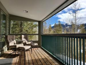 a screened in porch with two chairs and large windows at Saints John 2500 by Summit County Mountain Retreats in Snake River Health Services Incorporated Heliport