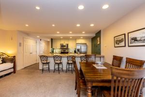 a kitchen and living room with a table and chairs at Saints John 2500 by Summit County Mountain Retreats in Snake River Health Services Incorporated Heliport