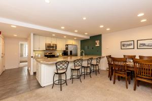 a kitchen with a bar and a group of chairs at Saints John 2500 by Summit County Mountain Retreats in Snake River Health Services Incorporated Heliport +23 photos