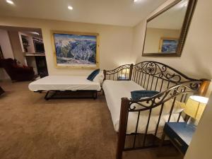 a living room with two beds and a mirror at Saints John 2500 by Summit County Mountain Retreats in Snake River Health Services Incorporated Heliport
