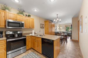 a kitchen with wooden cabinets and a stove top oven at Expedition Station 8576 by Summit County Mountain Retreats in Snake River Health Services Incorporated Heliport