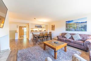 a living room with a couch and a table at Saints John 2520 by Summit County Mountain Retreats in Snake River Health Services Incorporated Heliport