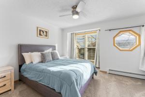 a bedroom with a bed and a window at Saddle Ridge Townhomes 253 by Summit County Mountain Retreats in Sentinel Island