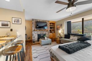a bedroom with a living room with a fireplace at Saints John 2539 by Summit County Mountain Retreats in Snake River Health Services Incorporated Heliport